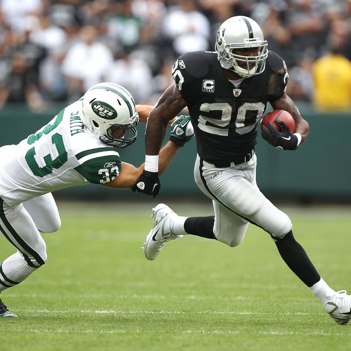 OAKLAND, CA - SEPTEMBER 25: Darren McFadden #20 of the Oakland Raiders runs against Eric Smith #33 of the New York Jets at O.co Coliseum on September 25, 2011 in Oakland, California. (Photo by Jed Jacobsohn/Getty Images)