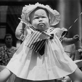 A young child is held aloft for a better view of the 1991 Desert Storm Victory Parade in New York.