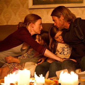 Left to right: Mireille Enos is Karin Lane, Sterling Jerins is Constance Lane, Abigail Hargrove is Rachel Lane, and Brad Pitt is Gerry Lane in WORLD WAR Z, from Paramount Pictures and Skydance Productions in association with Hemisphere Media Capital and GK Films.WWZ-02386R