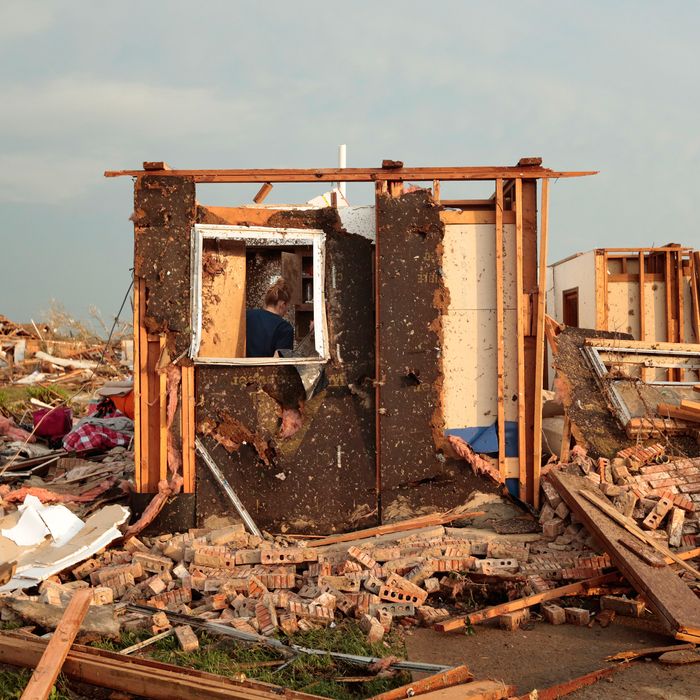 Dana Ulepich searches inside a room left standing at the back of her house destroyed after a powerful tornado ripped through the area on May 20, 2013 in Moore, Oklahoma. The tornado, reported to be at least EF4 strength and two miles wide, touched down in the Oklahoma City area on Monday killing at least 51 people.