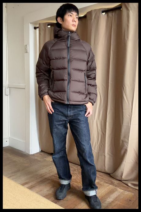 Photo of Strategist senior writer Michael Zhao wearing the Quince Men's Responsible Down Puffer in chocolate brown.