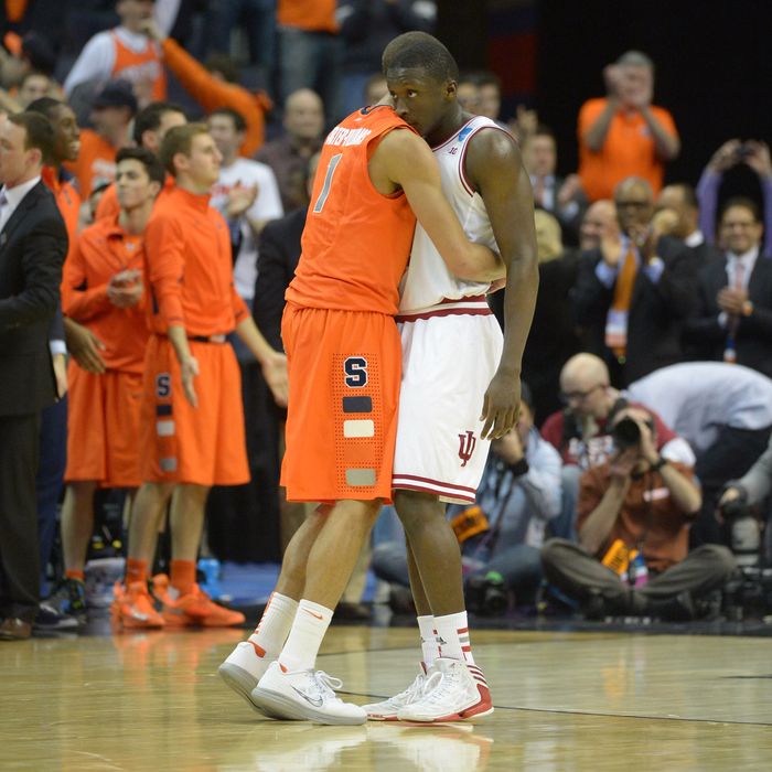 Syracuse guard Michael Carter-Williams (1) consoles Indiana Hoosiers guard Victor Oladipo (4) after Syracuse defeated Indiana 61-50 in game 2 of the NCAA east regional on March 28, 2013 in Washington, DC.