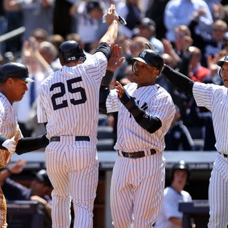 Alex Rodriguez #13, Mark Teixeira #25, Robinson Cano #24 and Raul Ibanez #27 of the New York Yankees celebrate after a three-run RBI double by Nick Swisher