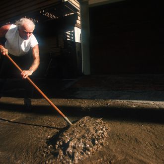 A man shovels away mudslide debris after an El Nino rainstorm February 9, 1998 in Malibu, CA. Million-dollar homes sustain damage or are completely destroyed after an El Nino rainstorm leads to erosion that causes a cliff to buckle.