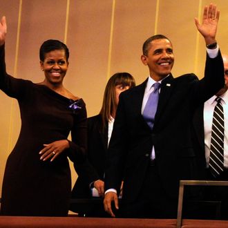 U.S. President Barack Obama and first lady Michelle Obama wave to guests as they arrive in their box at the Kennedy Center for the Performing Arts to attend the Let Freedom Ring Celebration on January 16, 2012 in Washington, DC.
