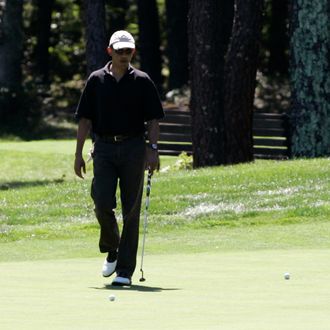 OAK BLUFFS, MA - AUGUST 23: U.S. President Barack Obama plays the first hole of the Farm Neck Golf Club while vacationing on Martha's Vineyard on August 23, 2011 in Oak Bluffs, Massachusetts. This is the third year the president has taken his vacation on Martha's Vineyard. (Photo by Matthew Healey-Pool/Getty Images)