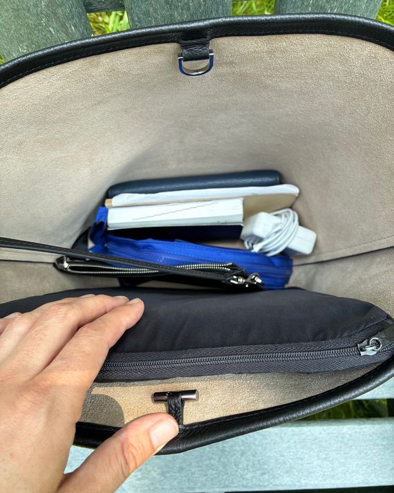 Bird’s-eye view of the Penelope bag with Corsillo’s work essentials inside, including a laptop and charger, monthly planner, small notebook, pencil case, and wallet.