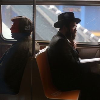 Passengers ride in a subway car in New York City.