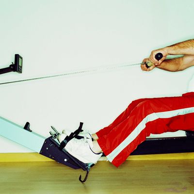 Side profile close-up of the legs of a man on an exercise machine 