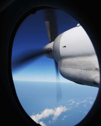 The engine of a Vietnamese Air Force Russian-made AN-27 seen through a window during a search operation over Vietnam's southern sea for missing Malaysia Airlines' flight MH370 on March 14, 2014. The needle-in-a-haystack hunt for the missing Malaysian airliner spread to the vast Indian Ocean after the White House cited 