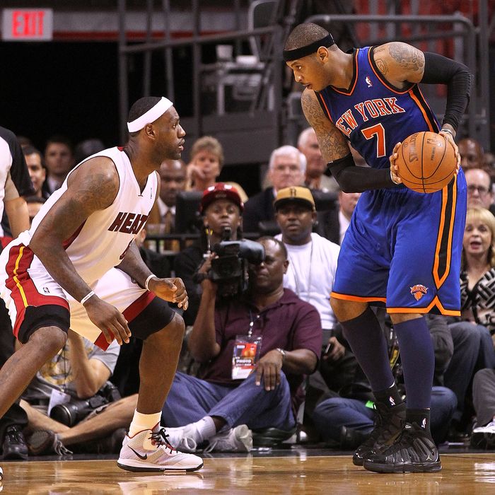 Carmelo Anthony #7 of the New York Knicks is guarded by LeBron James #6 of the Miami Heat during a game at American Airlines Arena on February 27, 2011 in Miami, Florida.