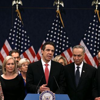 New York Gov. Andrew Cuomo (C) speaks to the media while flanked by members of the New York delegation on Capitol Hill on December 3, 2012 in Washington, DC. Gov. Cuomo visited law makers asking for $42 billion in appropriations for damage caused by Superstorm Sandy.