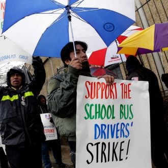 Bus drivers and supporters walk a picket line in front of a bus depot in New York, Wednesday, Jan. 16, 2013. More than 8,000 New York City school bus drivers and matrons went on strike over job protection Wednesday morning, leaving some 152,000 students, many disabled, trying to find other ways to get to school. 