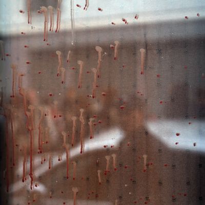 Dried blood can be seen on the window of the Carillon cafe in Paris Saturday Nov. 14, 2015, a day after over 120 people were killed in a series of shooting and explosions.
