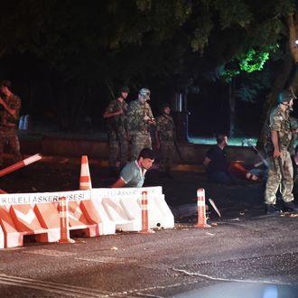 Turkish security officers detain unknown individuals on the side of the road on July 15, 2016 in Istanbul, during a security shutdown of the Bosphorus Bridge. 