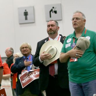 Delegates stand at attention during the national anthem during the Texas Republican Convention Friday, May 13, 2016, in Dallas. (AP Photo/LM Otero)