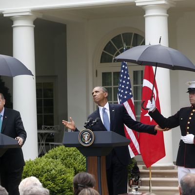 President Barack Obama, accompanied by Turkish Prime Minister Recep Tayyip Erdogan checks for rain during their joint news conference in the Rose Garden of the White House in Washington, Thursday, May 16, 2013. (AP Photo/Charles Dharapak)