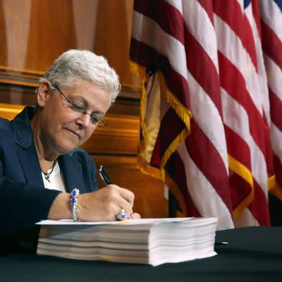 U.S. Environmental Protection Agency Administrator Gina McCarthy signs new regulations for power plants June 2, 2014 in Washington, DC. Bypassing Congress and using President Barack Obama's 'Climate Action Plan,' the new regulations will force more than 600 existing coal-fired power plants, the single largest source of greenhouse gas emission in the country, to reduce their carbon pollution 30 percent from 2005 levels by 2030. 
