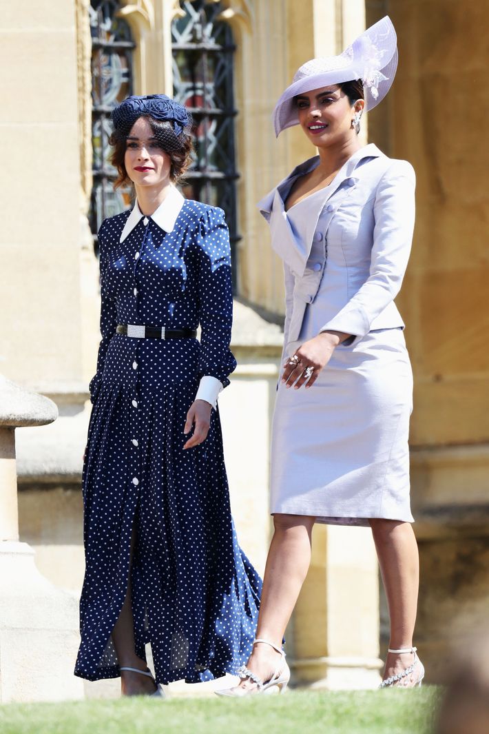 Suits actress Abigail Spencer (left) and Bollywood actress Priyanka Chopra  (second left) arrive at St George's Chapel in Windsor Castle for the  wedding of Prince Harry and Meghan Markle Stock Photo -