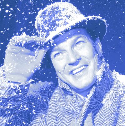 1950s 1960s smiling man outside in hat overcoat and gloves while snowing