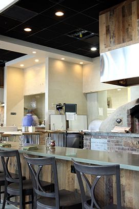 One of the restaurant's two primitive earth ovens is open to the dining room.