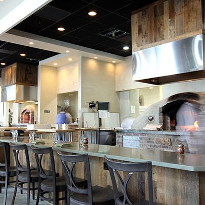 One of the restaurant's two primitive earth ovens is open to the dining room.