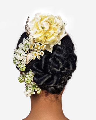 A knotted updo with lilacs and peonies.