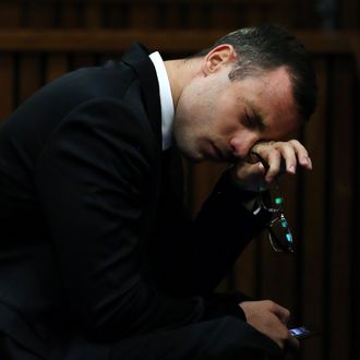 South African Paralympic track star Oscar Pistorius reacts during his trial for the murder of his girlfriend Reeva Steenkamp, at the North Gauteng High Court in Pretoria, on April 7, 2014. An emotional Oscar Pistorius took the stand as a witness in his defence on April 7, fighting through tears to apologise to the family of his girlfriend Reeva Steenkamp for killing her on Valentine's Day 2013. 