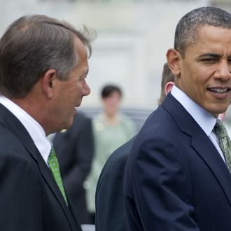 US President Barack Obama and Speaker of the House John Boehner (L) speak following a St. Patrick's Day Luncheon at the US Capitol in Washington, DC, March 20, 2012. 