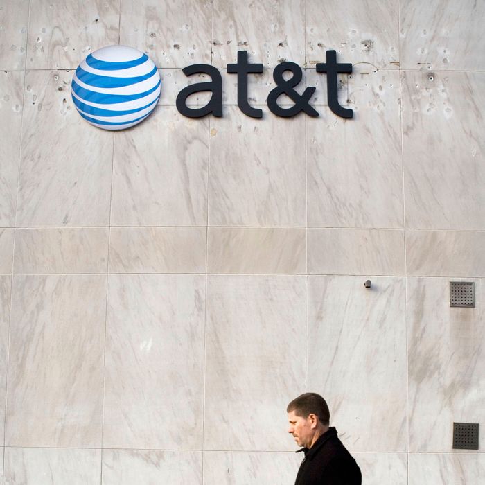 A pedestrian walks by an AT&T store in Downtown Brooklyn section of New York, U.S. on Tuesday, Dec. 11, 2007. Photographer: Ramin Talaie