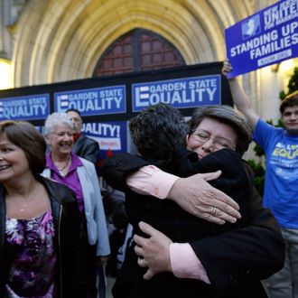 Cindy Meneghin, second from right, hugs her attorney Hayley Gorenberg during a rally at Garden State Equality in Montclair, N.J., hours after a Superior Court Judge ruled that New Jersey is unconstitutionally denying federal benefits to gay couples and must allow them to marry Friday, Sept. 27, 2013. Meneghin has been with her partner, Maureen Kilian, left, for 39 years. Judge Mary Jacobson ruled it legal for gay couples to marry in the state beginning Oct. 21, 2013. The ruling comes after a group of gay marriage supporters sued the state in July, days after the U.S. Supreme Court struck down key parts of a law that blocked the federal government from granting benefits to gay couples.