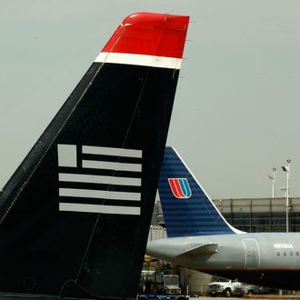 WASHINGTON - APRIL 08: Airplanes belonging to US Airways and United Airlines stand parked at their gates at Ronald Reagan National Airport April 8, 2010 in Washington, DC. The two airlines are in merger talks once again and if the deal goes through they would form one of the world's largest airlines. (Photo by Chip Somodevilla/Getty Images)