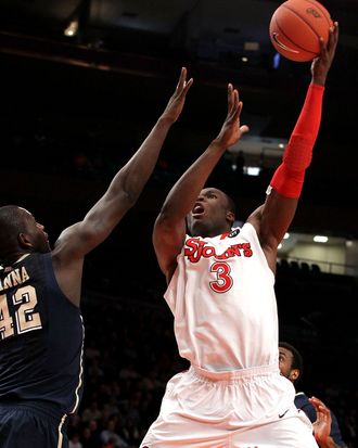 God'sgift Achiuwa #3 of the St. John's Red Storm takes a shot against Talib Zanna #42 of the Pittsburgh Panthers during their first round game of the 2012 Big East Men's Basketball Tournament at Madison Square Garden on March 6, 2012 in New York City.
