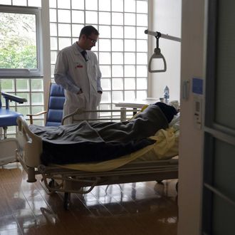 Doctor Stephane Mercier, Head of the palliative care unit, visits a patient at the palliative care unit of the AP-HP Paul-Brousse Hospital in Villejuif near Paris March 4, 2015. 