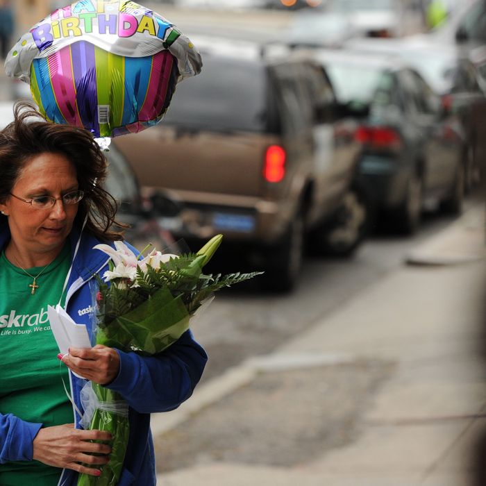 Diane Hohen, with TaskRabbit, delivers a bouquet of flowers in Boston on March 29, 2012. TaskRabbit is a task and errand service that allows people to hire others to do small jobs.