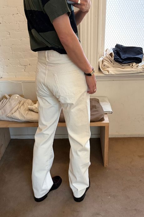 Man in white jeans facing away from the camera