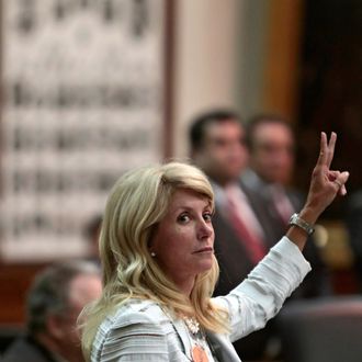 State Sen. Wendy Davis (D-Ft. Worth) holds up two fingers against the anti-abortion bill SB5, which was up for a vote on the last day of the legislative special session June 25, 2013 in Austin, Texas. A combination of Sen. Davis' 13-hour filibuster and protests by reproductive rights advocates helped to ultimately defeat the controversial abortion legislation at midnight. 