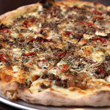 The formidable 'New Vermont Sausage,' topped with sausage made from humanely-raised pork, sun-dried tomatoes, Blythdale Farm Cooksville Grana, fresh herbs, organic mushrooms, whole milk mozzarella, and more.