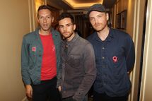 LONDON, ENGLAND - OCTOBER 24:  (UK TABLOID NEWSPAPERS OUT) Jonny Buckland, Chris Martin and Guy Berryman of Coldplay pose in the press room with their Best Act in the World Today Award at The 2011 Q Awards at The Grosvenor House Hotel on October 24, 2011 in London, United Kingdom.  (Photo by Dave Hogan/Getty Images)