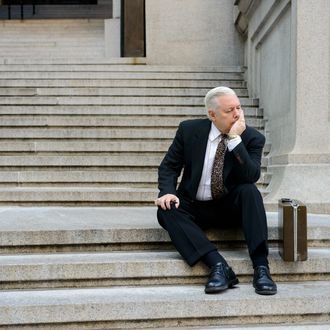 Manhattan, New York City, New York State, USA --- Sad businessman on steps --- Image by ? Image Source/Corbis