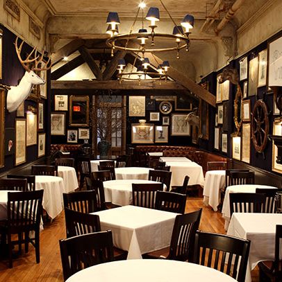 The wood-paneled room has been redecorated with taxidermy, nautical items, and lots of framed prints and lithographs.