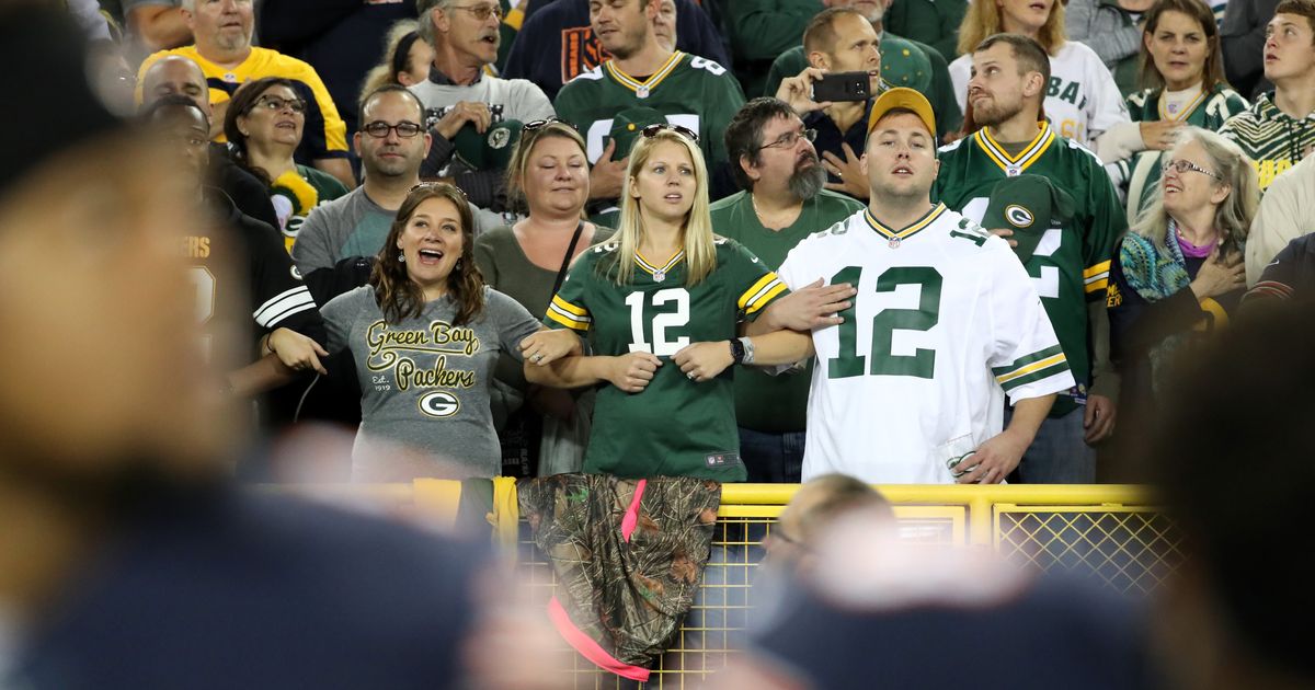 Green Bay Packers' fans who became owners stand with team