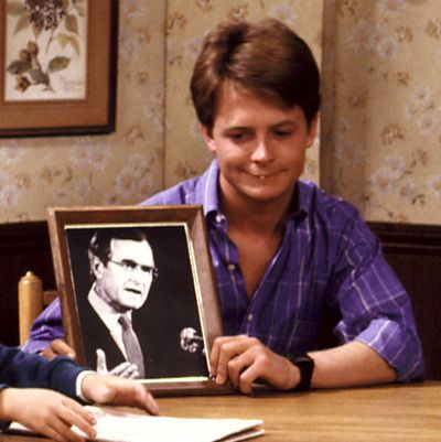 FAMILY TIES, Brian Bonsall, Michael J. Fox, Alex Keaton holds a picture of President Bush. Yr.7, Ep, (Heartstrings), 12/4/88, 1982-89.