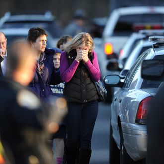 Residents grieve following a shooting December 14, 2012 at Sandy Hook Elementary School on December 14, 2012 in Newtown, Connecticut. At least 26 people, including 20 young children, were killed when a gunman assaulted the school and another body was found dead at a second linked crime scene, police said. Police spokesman Lieutenant Paul Vance told reporters that the attacker killed 20 children and six adults, including someone that he lived with, at the Sandy Hook Elementary School in Newtown, Connecticut. The gunman also died at the scene, and a 28th body was found elsewhere.