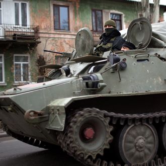 An amored personnel carrier (APC) rolls on November 12, 2014 on a main road in rebel-territory near the village of Torez, east of Donetsk, in eastern Ukraine. The UN Security Council will hold an emergency meetingon November 12 following reports of Russia's latest military incursion in Ukraine, diplomats said. The meeting was requested by the United States after NATO said columns of Russian tanks, artillery and combat troops had entered eastern Ukraine in the past two days.