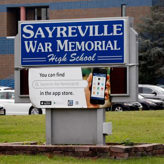 The entrance to Sayreville War Memorial High School is shown Tuesday, Oct. 7, 2014, in Sayreville, N.J. Officials at a school, which has won three sectional titles over the past four years, canceled the football season amid allegations of harassment, intimidation and bullying among players. (AP Photo/Mel Evans)