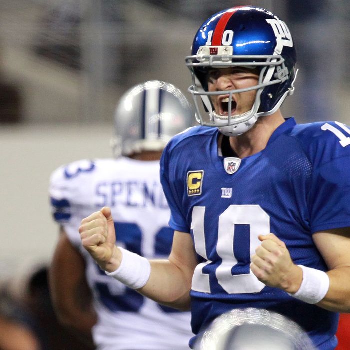 ARLINGTON, TX - DECEMBER 11: Eli Manning #10 of the New York Giants celebrates a touchdown against the Dallas Cowboys in the fourth quarter at Cowboys Stadium on December 11, 2011 in Arlington, Texas. (Photo by Ronald Martinez/Getty Images)