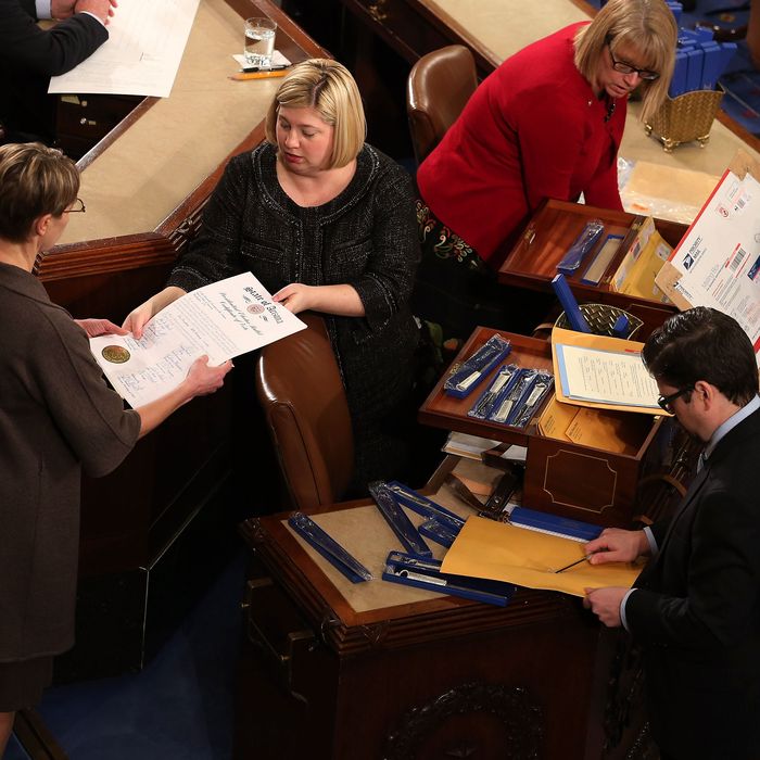 Congressional clerks help unseal and organize the Electorial College votes from the 50 states in the House of Representatives chamber at the U.S. Captiol January 4, 2013 in Washington, DC. The votes were tallied during a joint session of the 113th Congress. President Barack Obama and Biden received 332 votes to be reelected.