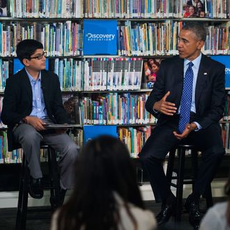 30 Apr 2015, Washington, DC, USA --- US President Barack Obama (R), with student moderator Osman Yaya (L), responds to a question while participating in a 