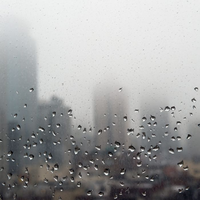 Raindrops are seen on a window as morning fog obscures the top floors of high rise buildings on the east side of Manhattan May 1, 2014 in New York. 